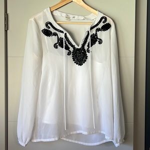 White long sleeve blouse with delicate black detailing on front
